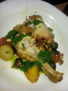 a roast chicken dish with potatoes and a cacciatore type of sauce 